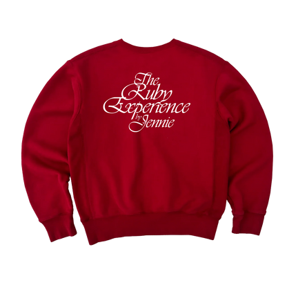 Back view of a unisex red crewneck sweatshirt featuring “The Ruby Experience by Jennie” design printed in white on the back.